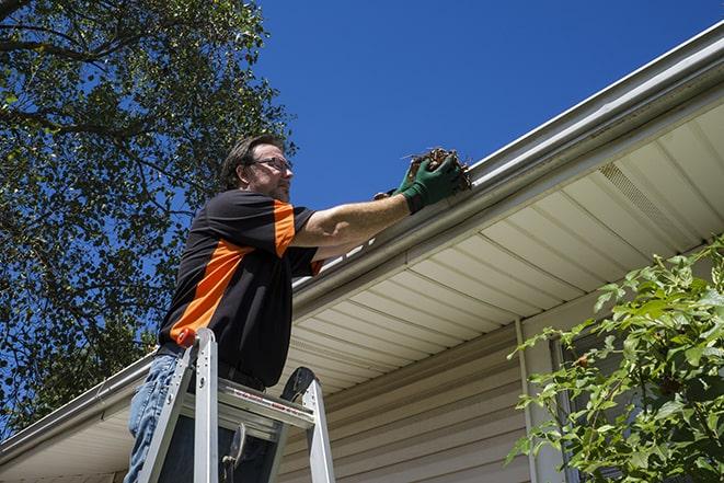 fixing a leaky gutter with new screws and brackets in Hacienda Heights, CA